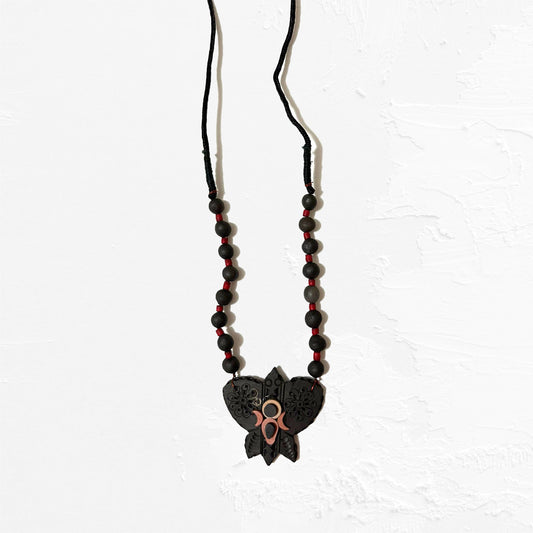 Necklace with black and red beads and a butterfly pendant on a white background