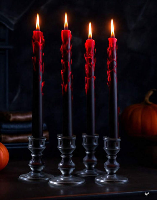 Five black candles with red wax dripping into clear glass holders on a dark background.