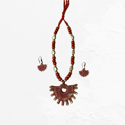 A handcrafted terracotta necklace and matching earrings featuring a red fan-shaped pendant with gold accents and a beaded chain. The set is displayed on a white background.